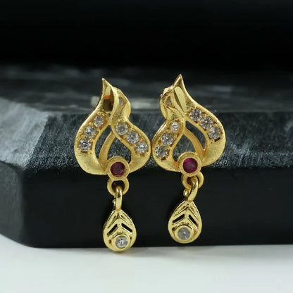 Classic Gold Tone Designer Leaf Earrings With Ruby Accent And Graceful Hanging Drop