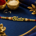 Bhaiya Rakhi – Golden Name Design with Peach Brown Beads