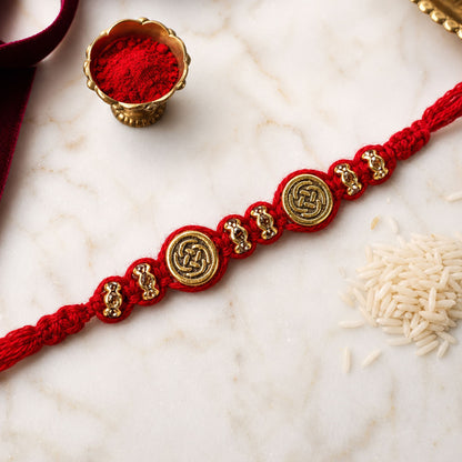 Red Braided Rakhi with a Row of Antique Gold Coin-Style Charms