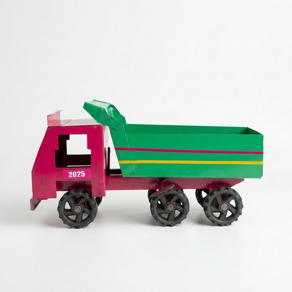 Kids playing with metal dumper truck toy outdoors
