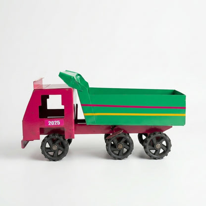 Kids playing with metal dumper truck toy outdoors