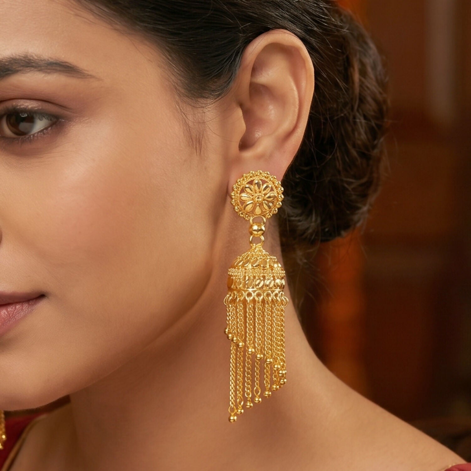 Close-up of intricate detailing on golden jhumka earrings