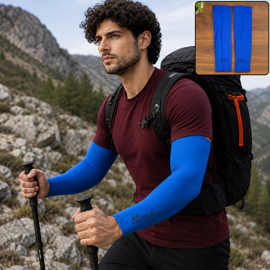 A man hiking on a rocky trail wears blue arm sleeves, a maroon t-shirt, and a black backpack.