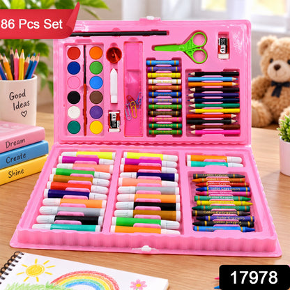 The pink art kit, open on a wooden table, shows various art supplies; a "86 Pcs Set" label is at the top left.