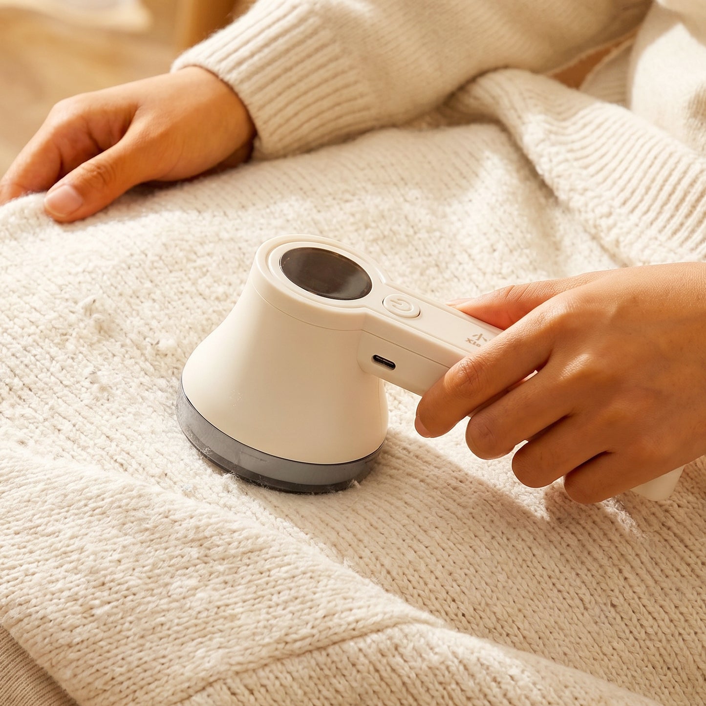Fabric Shaver in Use on Sweater