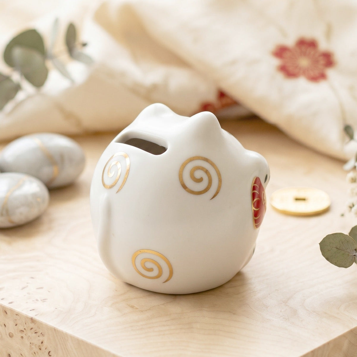 Gift-ready ceramic cat piggy bank, charming for all ages.