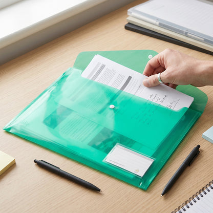 Plastic document folder open while inserting papers