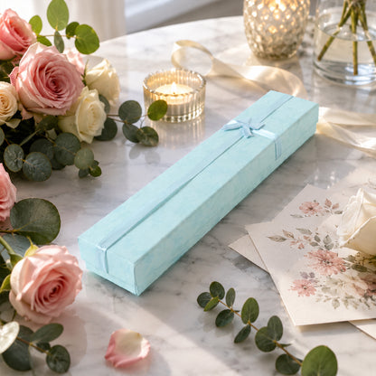Long gift box with bow in floral setting