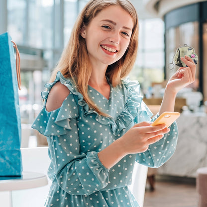 Mini coin purse keychain carried by woman