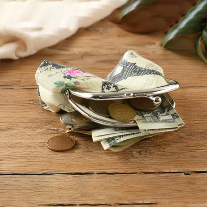 Small clasp purse holding coins and cash