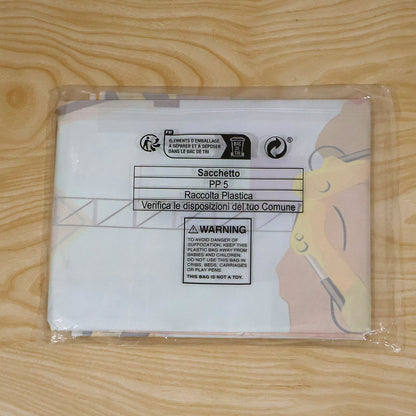 A folded construction-themed birthday banner sealed in a clear plastic bag with recycling information and a warning label.