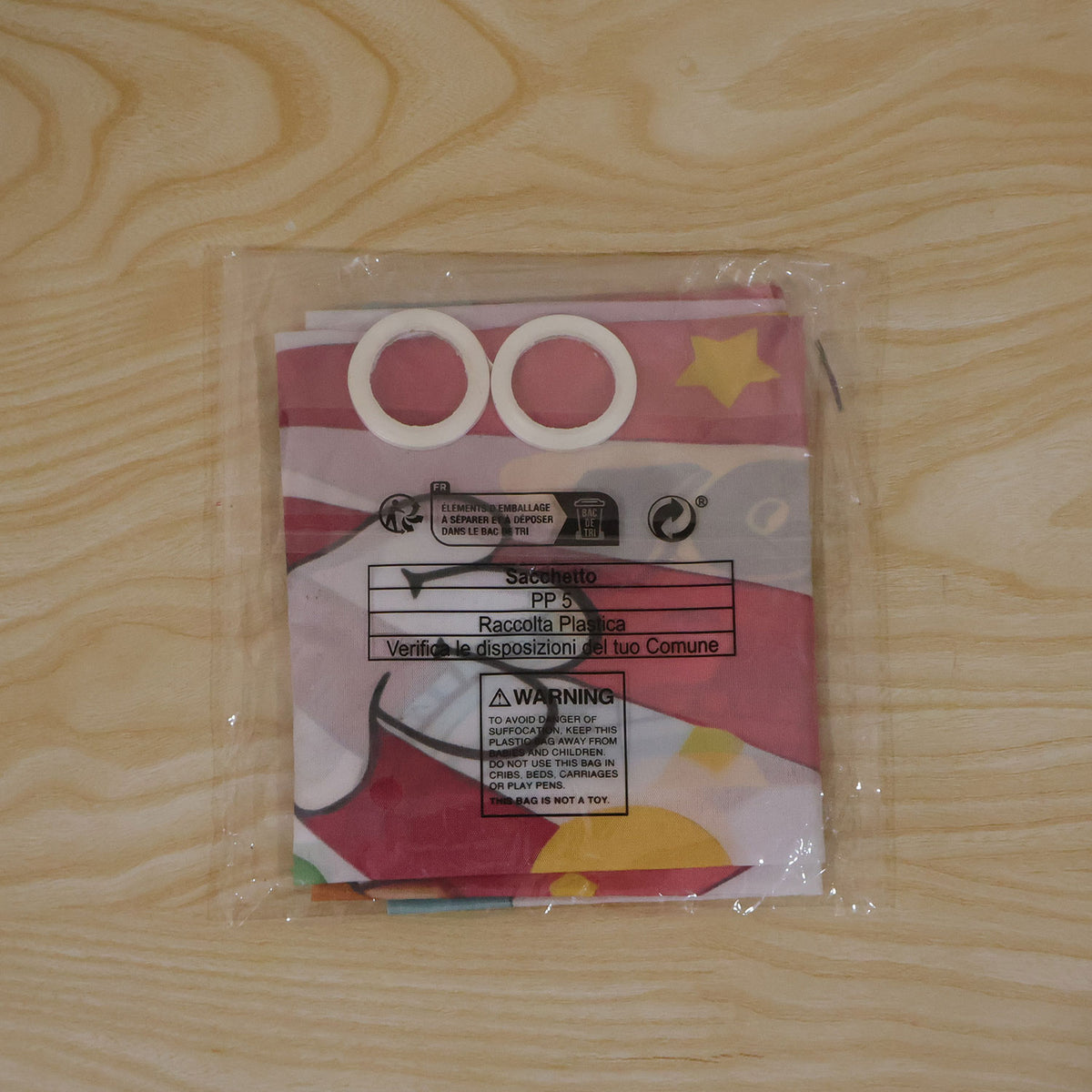 Actual photograph of packaged clown target banner with accessory rolls