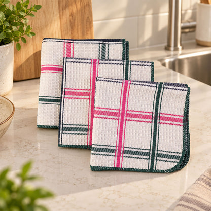 Three folded multipurpose dish cleaning cloths