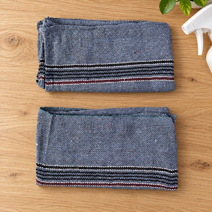Two folded woven floor cleaning cloths