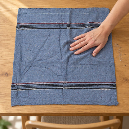 Woven cleaning cloth wiping a table