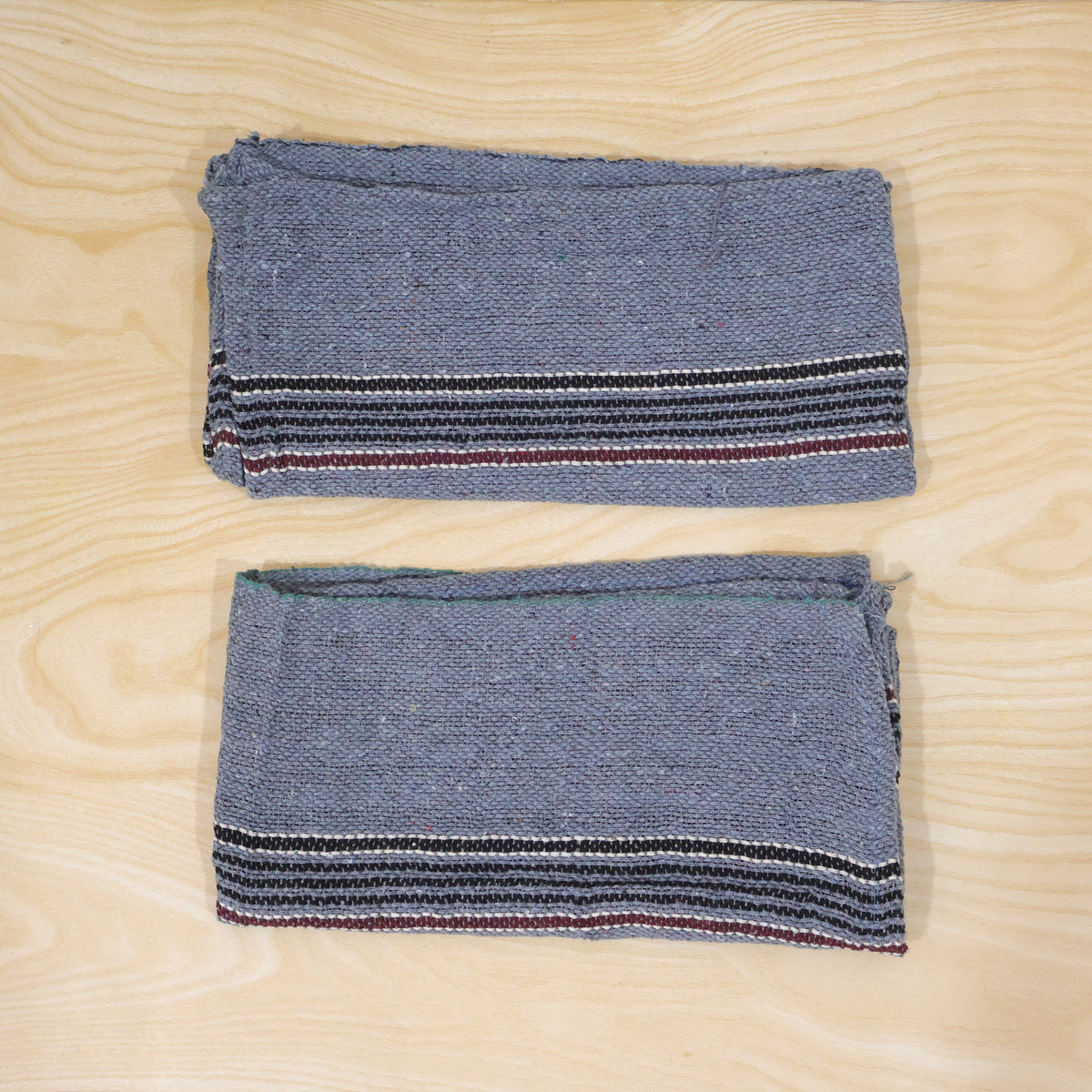 Actual photograph of two folded floor cleaning cloths