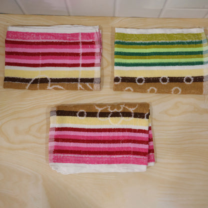 Actual photograph of three folded striped cleaning cloths