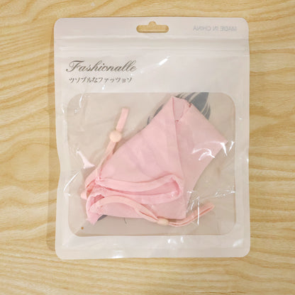Actual photograph of face cover in plastic retail packaging