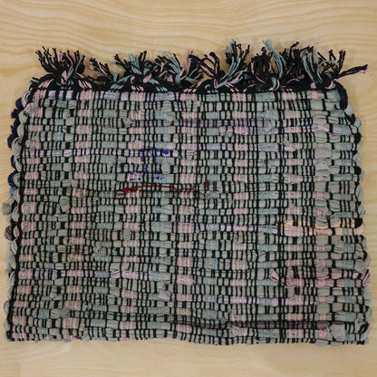 Actual photograph of woven floor mat with tassel edges