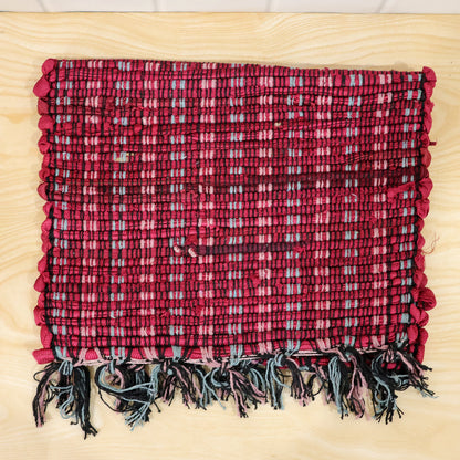 Actual photograph of woven floor mat with tassel fringe