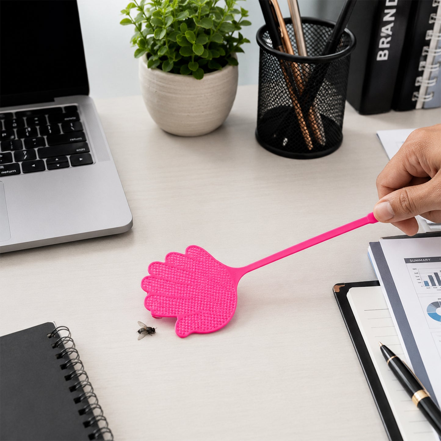 Hand shaped fly swatter in use