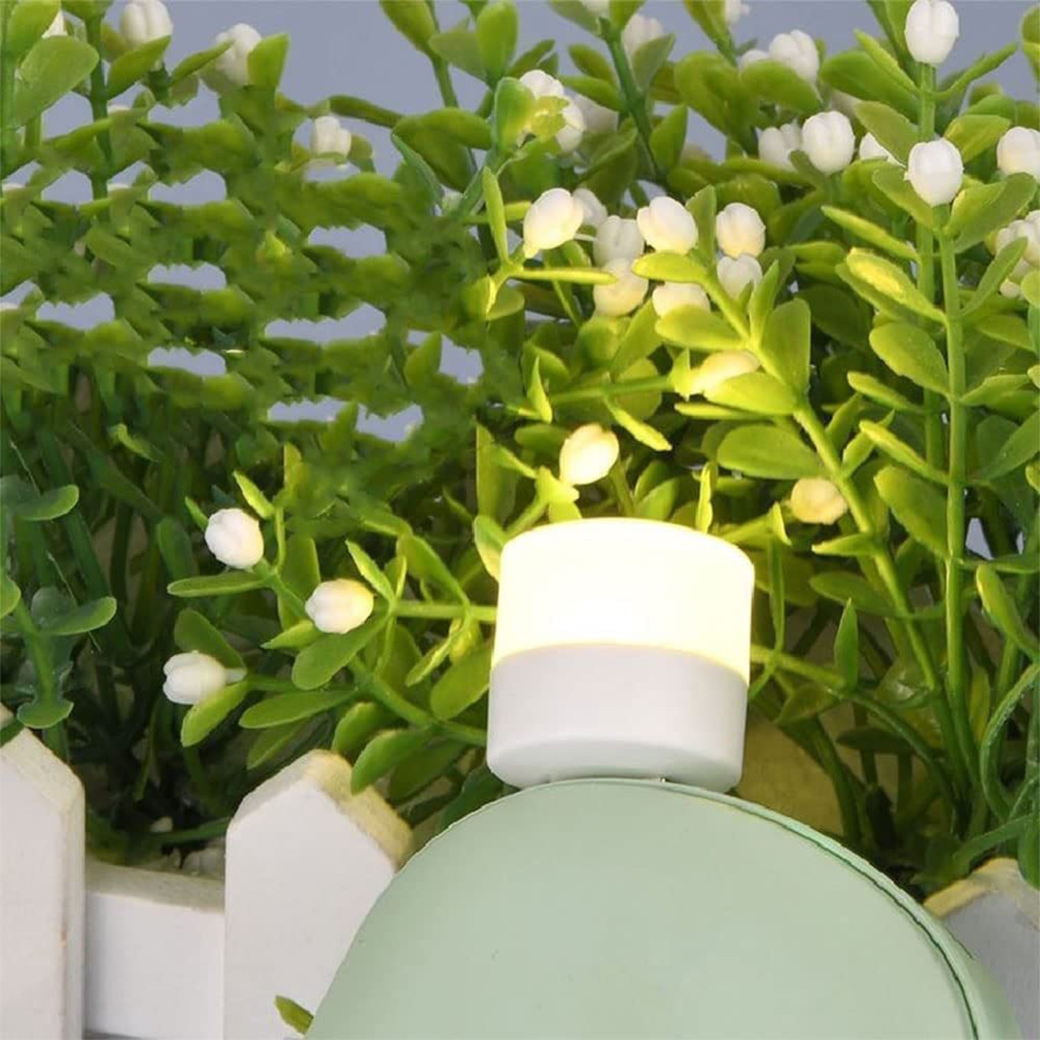Mini USB light glowing near decorative plants