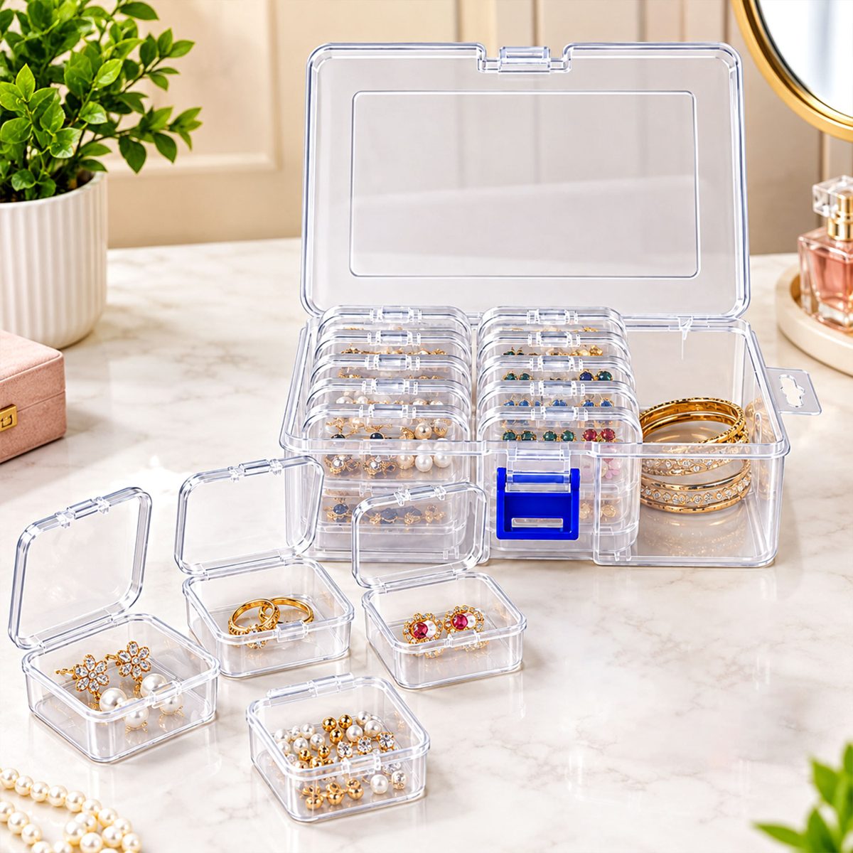 A clear plastic storage box with an open lid, revealing multiple small cases filled with various jewelry items. A – view 2