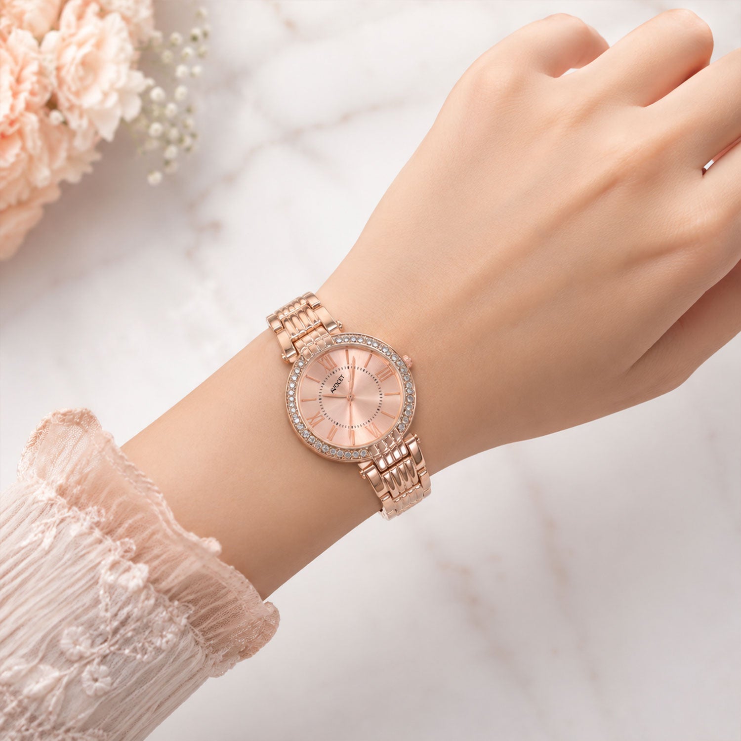 Overhead shot of the women's rose gold watch, revealing the full design of its dial and strap.