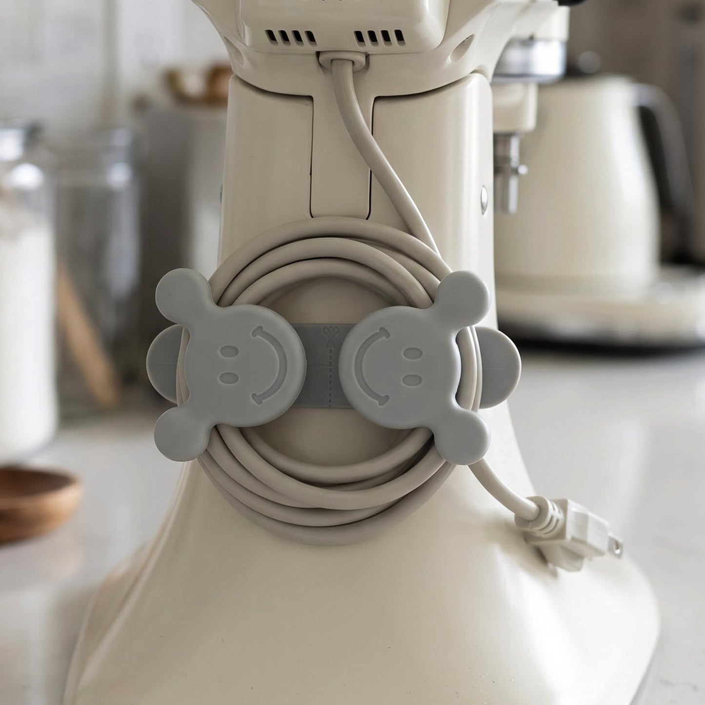 Self adhesive wall hook cable organizer on kitchen appliance