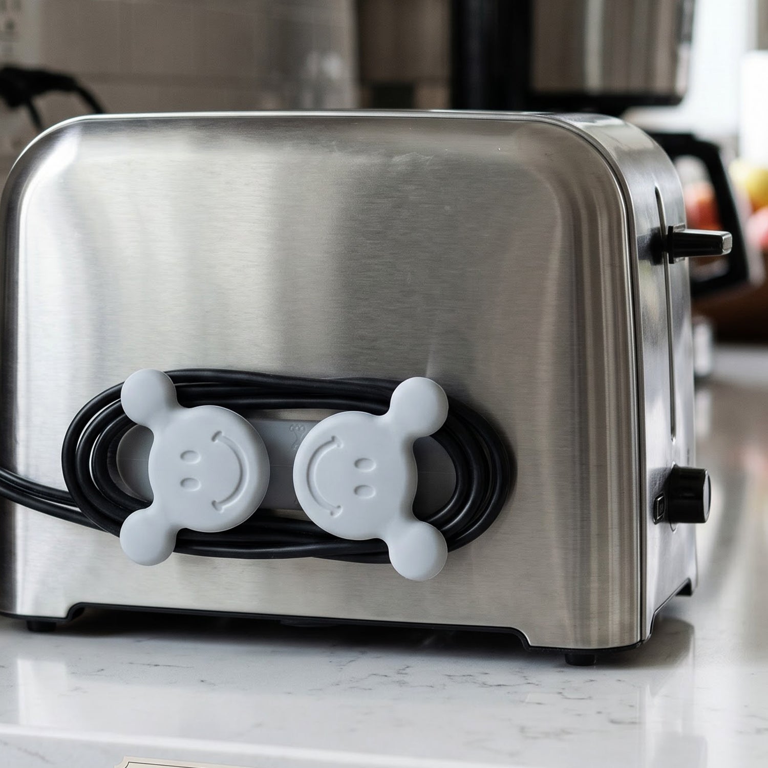 Adhesive cable organizer hook on toaster
