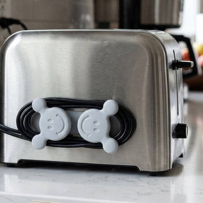 Adhesive cable organizer hook on toaster