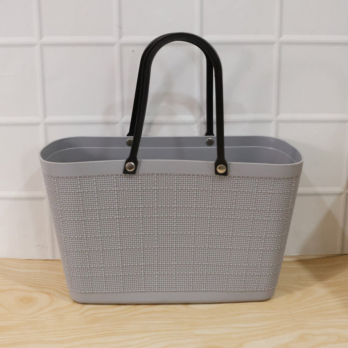 Close-up of sturdy handles and woven texture of reusable shopping tote