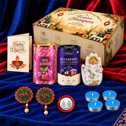 A Diwali gift set featuring a Ganesha idol, two tins of flavored almonds, a greeting card, four blue tealights, and two