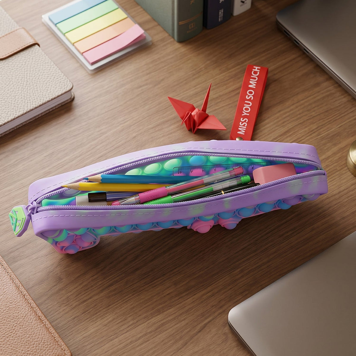 Detailed view of push pop bubbles and keychain charm in silicone pouch.