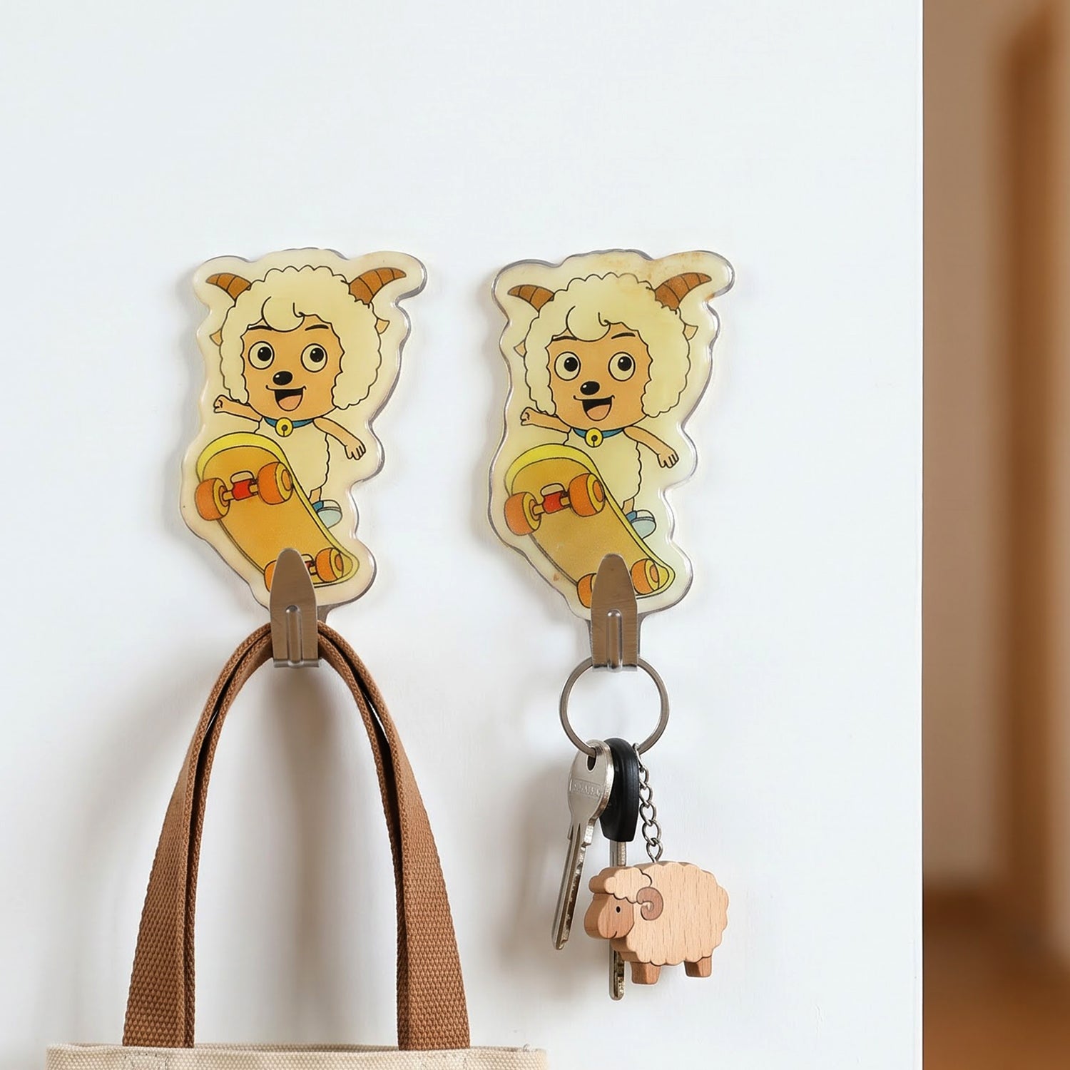 Cartoon adhesive wall hooks holding keys and bag