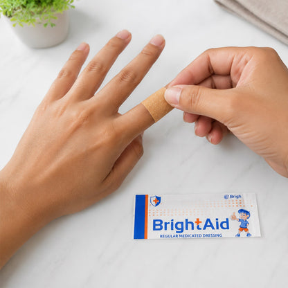 Hand applying a BrightAid adhesive bandage to a minor cut.
