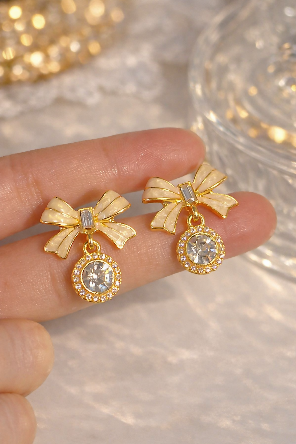 Pair of elegant bow crystal drop earrings displayed vertically