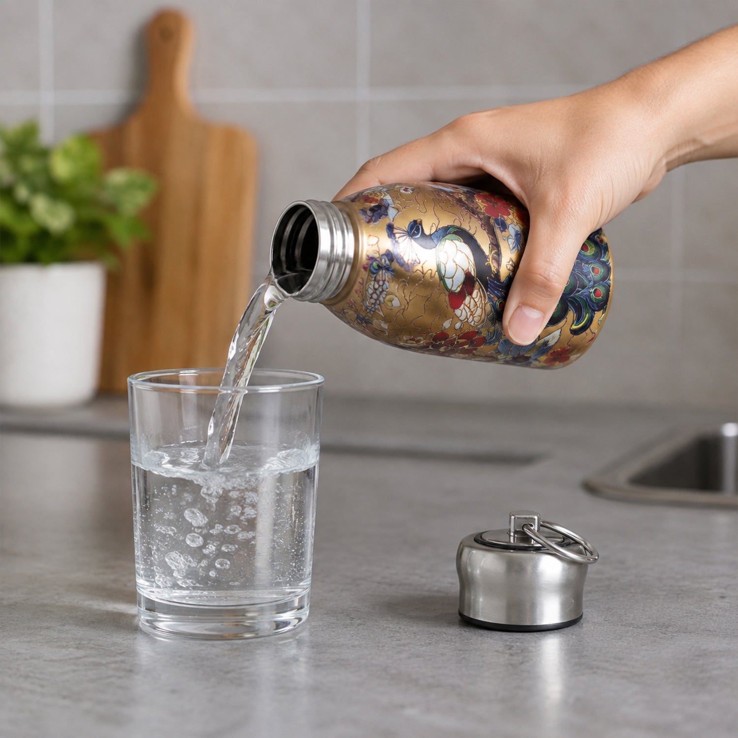 Wide mouth vacuum bottle pouring water