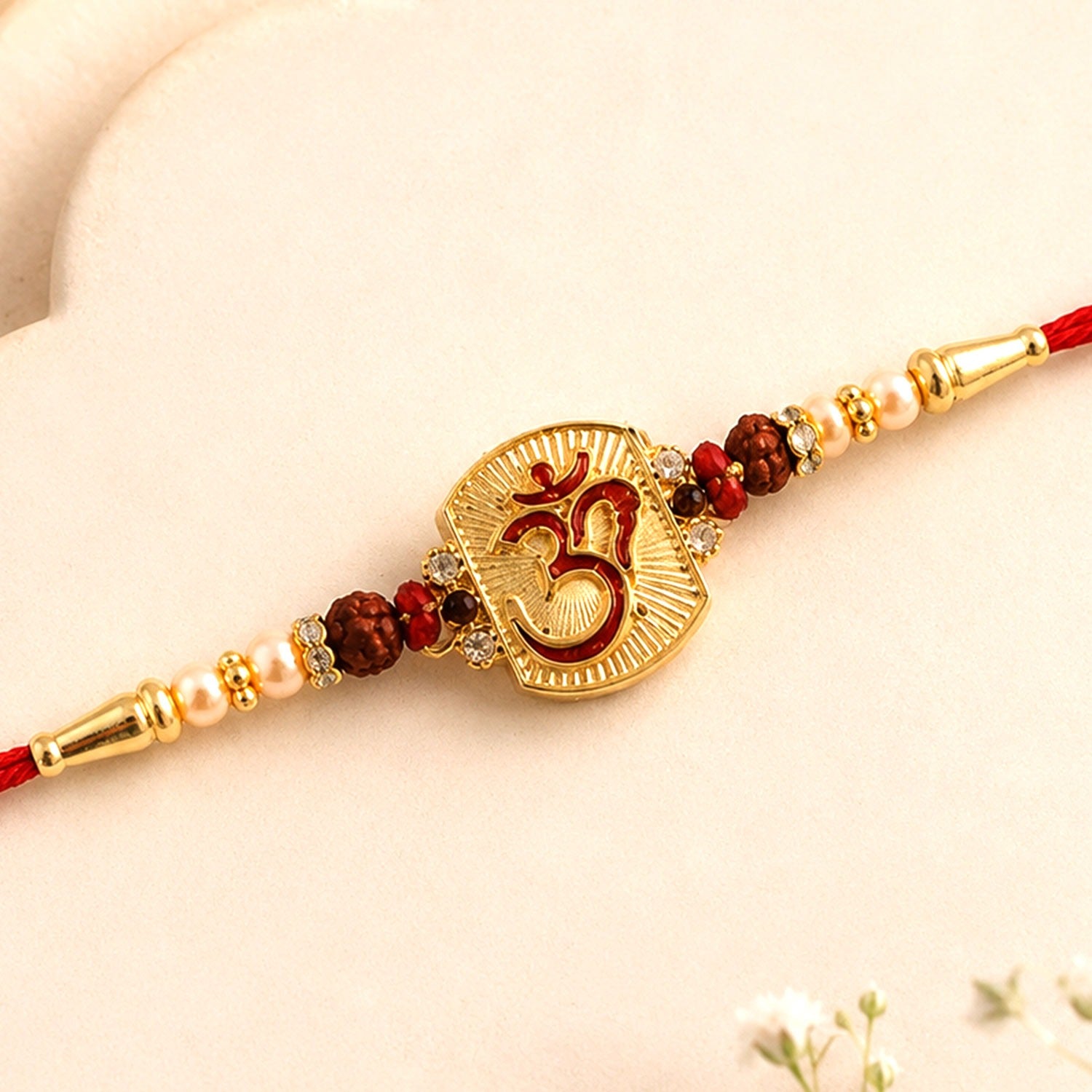 Front view of an Om Designer Rudraksha Beads Rakhi for Raksha Bandhan.