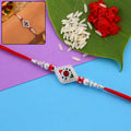 Rakhi – Elegant Silver Design with Red Stone & Pearl Beads