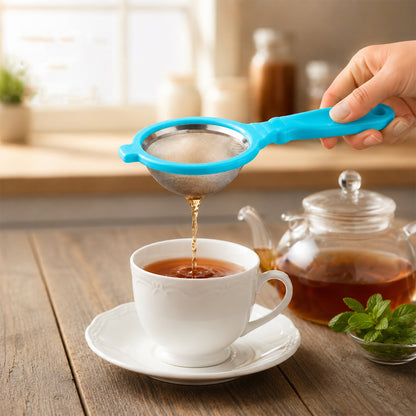 Mesh tea strainer filtering tea into cup