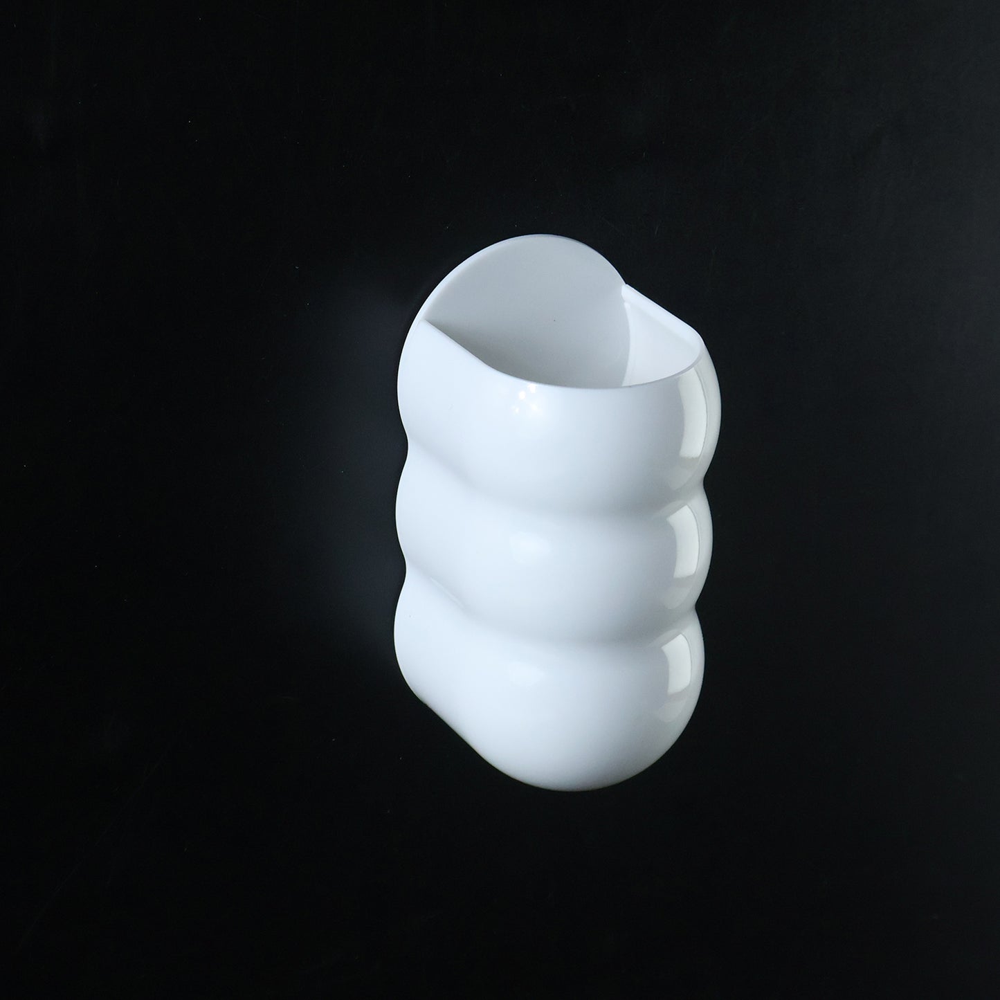 White plastic caterpillar shape wall storage holder side view