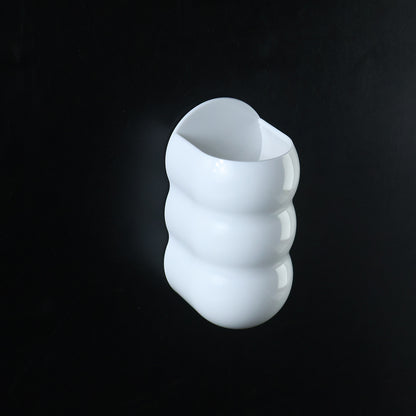 White plastic caterpillar shape wall storage holder side view
