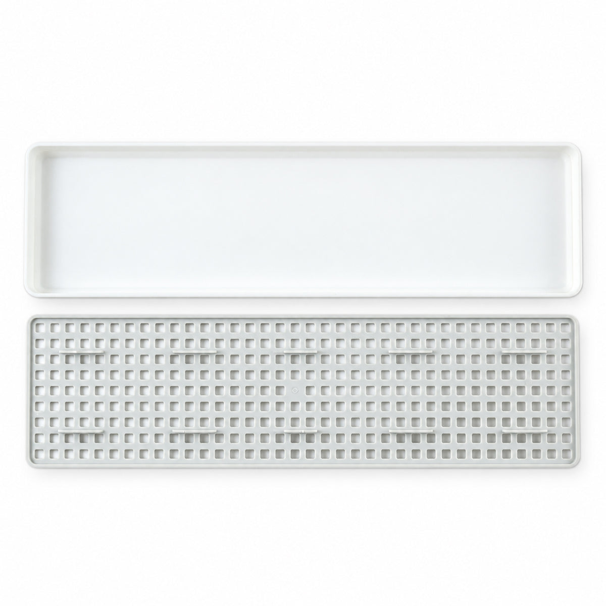Plastic drain rack components on white background