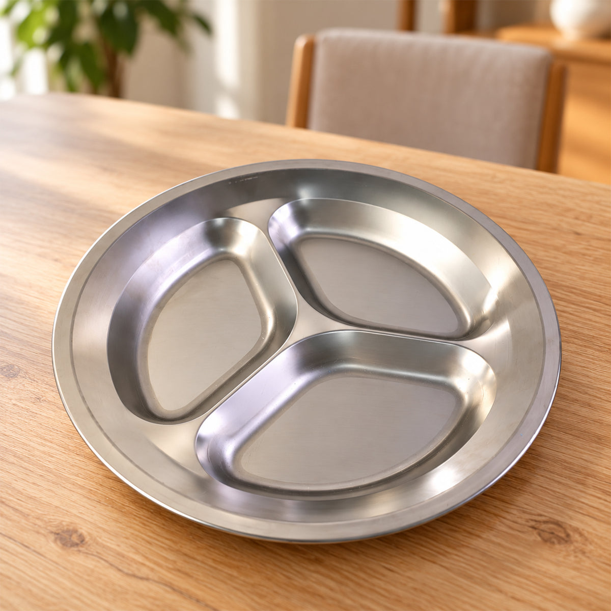 Stainless steel three compartment plate - tabletop view