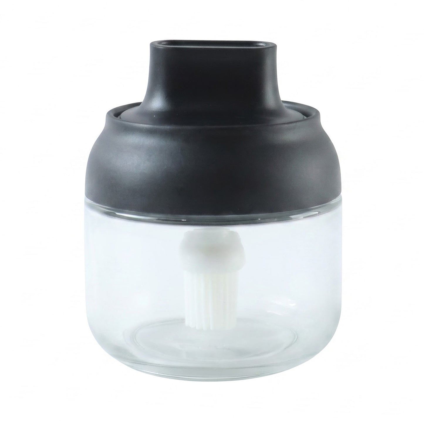 Round jar oil dispenser on white background