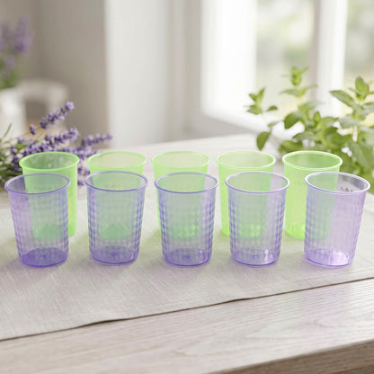 Ten colorful plastic drinking glasses arranged indoors
