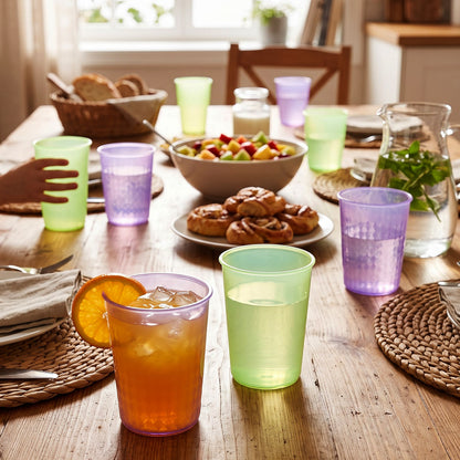 Colorful plastic drinkware on dining table