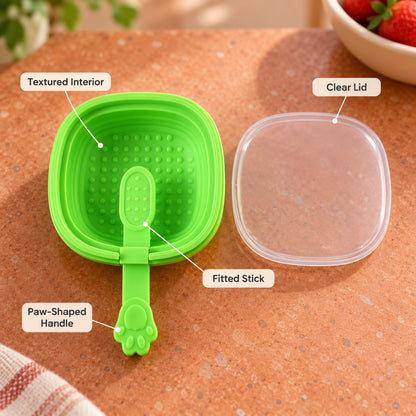 A green silicone mold with a paw handle and clear lid is labeled with its textured interior, fitted stick, and paw-shaped