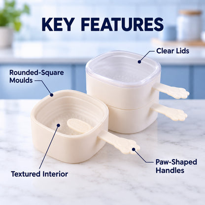 Two beige square molds with paw handles, one stacked, one open, highlighting clear lids and textured interior.